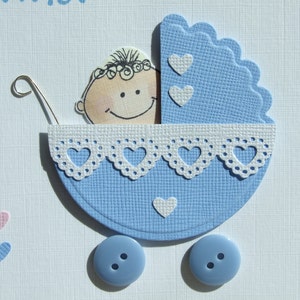 May include: A blue and white baby carriage with a white lace trim and a smiling baby face inside. The carriage has two blue buttons on the wheels.