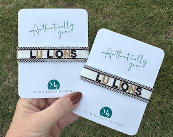 Pulsera bordada Lindenwood LU Lions: Joyería de lona tejida negra y dorada