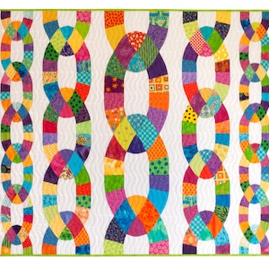 May include: A colorful quilt with a chain link pattern. The quilt is made of various fabrics in shades of red, orange, yellow, green, blue, purple, and pink. The quilt is quilted with a white background.