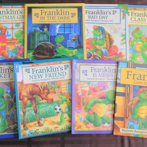 May include: A collection of children's books featuring the character Franklin the Turtle. Titles include "Franklin's Christmas Gift," "Franklin in the Dark," and "Franklin Goes to School." The books have colorful illustrations and are by Paulette Bourgeois and Brenda Clark.