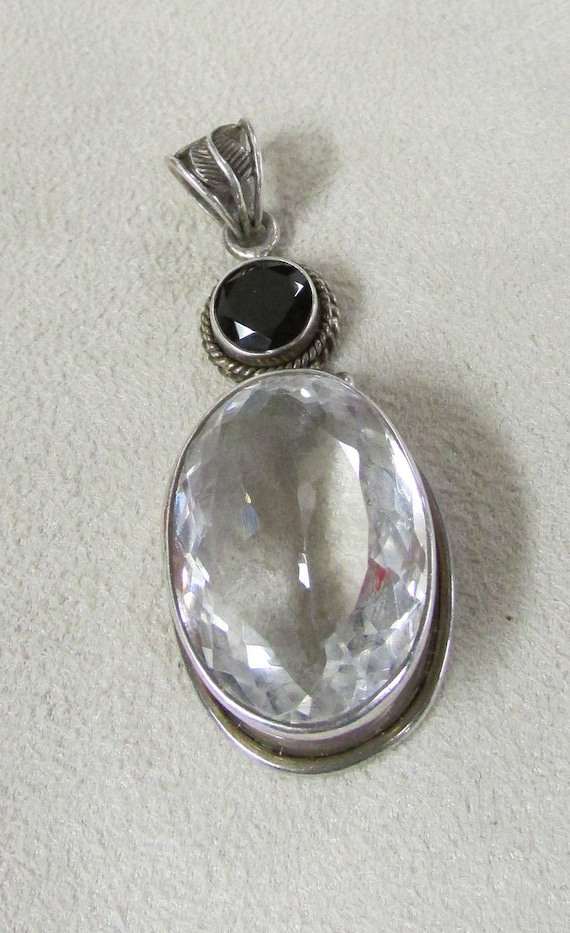 Clear Faceted Stone and Garnet Pendant +