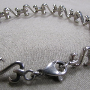 Sterling Silver Stylized Heart Link Bracelet +