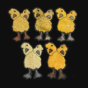 May include: Five appliqued duckling patches with two heads each, in shades of yellow, gold, and tan, with black outlines. The ducklings have brown, gray, and black feet. The background is solid black.