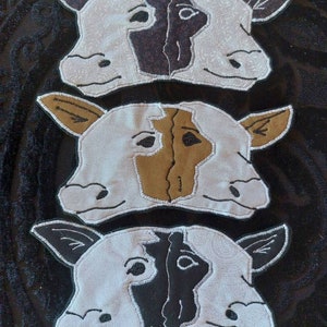 May include: Three felt cow masks, each with a different colored patch on the face. The top mask has a black patch, the middle mask has a brown patch, and the bottom mask has a black patch.