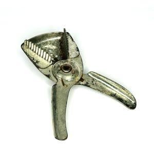 May include: A white ceramic mug with a black handle and the text "But First, Coffee" in a bold, black font. The mug is set against a blurred background, suggesting a cozy setting.