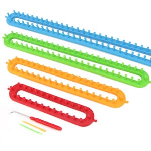May include: A set of four long, oval-shaped plastic knitting looms in blue, green, orange, and red, each featuring a series of upright pegs along the edges. Included are a metal hook tool with a red handle and two small plastic needles.