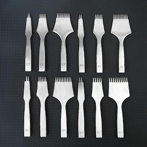 May include: A set of twelve silver-colored metal leather stitching chisels arranged in two rows. Each tool features a varying number of prongs and is clearly stamped with numerical size markings of 2.7, 3.0, 3.38, or 3.85 on the handle.