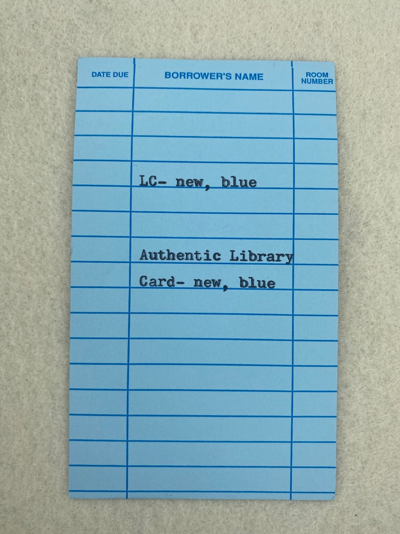 May include: A blue library card with the text "LC-new, blue" and "Authentic Library Card-new, blue". The card has fields for "Date Due", "Borrower's Name", and "Room Number".
