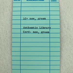 May include: A light blue library card with the text "LC= new, green" and "Authentic Library Card- new, green".
