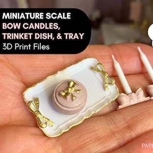 May include: A miniature set of 3D printed bow candles, trinket dish, and tray. The set features two white candles in pink holders, a pink trinket box with a gold bow, and a white tray with gold trim and bow details. The image includes the text "Instant download (STL files)".