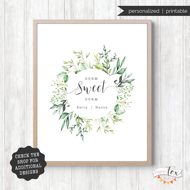 May include: A printable dorm room sign featuring a watercolour wreath of green leaves and the text "Dorm Sweet Dorm" with the names "Emily" and "Hanna" below.