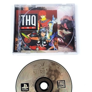 May include: A clear plastic case containing a PlayStation game disc. The case features a colorful graphic with the THQ Inc. logo. Below, a silver disc with the text "WCW NITRO" and the PlayStation logo is visible.
