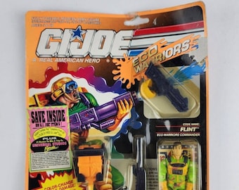May include: A plastic action figure of Flint, a G.I. Joe Eco-Warrior, in a green and yellow uniform. The figure is holding a water gun that shoots water. The packaging includes a save inside offer on G.I. Joe items.