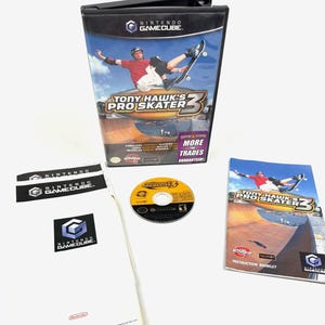 May include: A complete Nintendo GameCube game, "Tony Hawk's Pro Skater 3," featuring the game case, disc, instruction booklet, and inserts. The case shows a skateboarder performing a trick. The disc is yellow and the instruction booklet has the game's title.