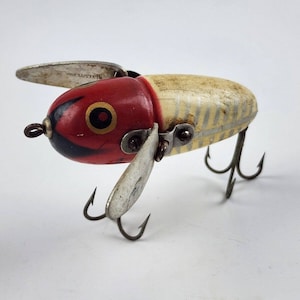 This 4" antique Heddon Basser wood fishing lure is from the