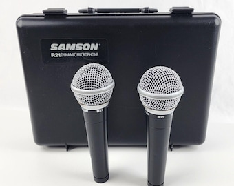 May include: Two black Samson R21 dynamic microphones with silver grilles in a black carrying case.