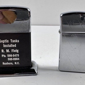 Lot 2 Lighters 1- Zippo 1- Unknown Advertising Septic Tank Install w/Base missg