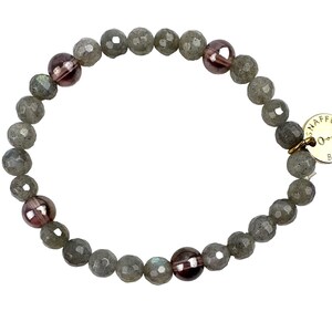 May include: A gray and purple beaded bracelet with a gold charm that says "Snaffle Bit".