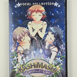 May include: A DVD case with the title "Kashimashi Girl meets Girl" and "Vocal Collection" text. The cover art features three anime-style girls with closed eyes, surrounded by flowers, on a dark blue background.