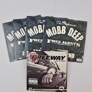 May include: A collection of music CDs featuring the artists Mobb Deep and Freeway. The Mobb Deep CDs have a dark, textured background with white text. The Freeway CD features a black and white image of a person in a car with the text "Freeway" and "Parental Advisory".