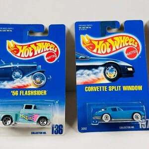 May include: Four Hot Wheels die-cast toy cars on blue card packaging. The cars are a blue '32 Ford Delivery, a blue '56 Flashsider, a blue Corvette Split Window, and a white Custom Corvette. The cars are part of a collector series.