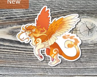 May include: A sticker featuring a mythical creature with orange and cream coloring. The creature has large wings, a lion-like body, and a human-like face. The word "New" is in a brown rectangle in the upper left corner.