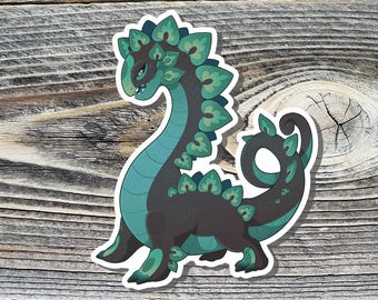 May include: A sticker of a cartoon green and black creature with a long neck and a tail curled around its body. The creature has a spiky, leafy design on its back and neck.