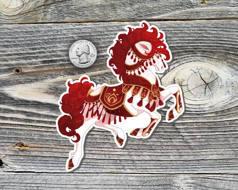 May include: A sticker featuring a white horse with red and gold decorative elements. The horse has a flowing red mane and tail, and is adorned with tassels and ornate designs. A U.S. quarter is next to the sticker for size reference.