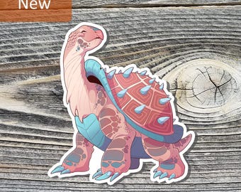 May include: A sticker featuring a cartoon turtle with a pink and blue color scheme. The turtle has a patterned shell with blue spikes and the word "New" in a brown rectangle.