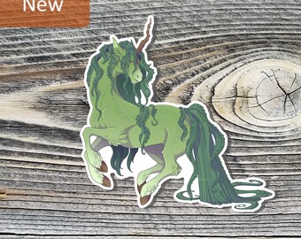 May include: A die-cut sticker featuring a mythical unicorn with light green skin, a long spiraled horn, and flowing dark green mane and tail that resemble tangled vines or seaweed. The creature is depicted in a dynamic, leaping pose.