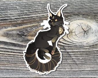 May include: A black cat sticker with a stylized design. The cat has long ears, a fluffy tail, and gold accents. The tail is curled into a spiral shape and adorned with a gold chain. The sticker is on a wooden background.