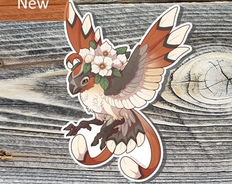 May include: A sticker featuring a stylized bird with brown, tan, and white feathers, adorned with a floral crown. The bird has a long, curved tail and is labeled "New" in a brown rectangle.