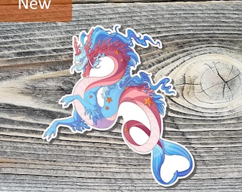 May include: A die-cut sticker featuring a serpentine dragon with a pink and blue body, flowing blue mane, coral-like antlers, and small orange starfish accents. The dragon has a long, curved tail ending in a blue fin, rendered in a flat illustration style.