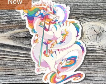 May include: A sticker featuring a white dragon with rainbow accents. The dragon has a long body, a flowing mane, and holds a staff. The sticker has a "New" label in the upper left corner.