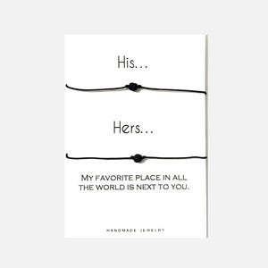 May include: Two black string bracelets with black beads, on a white card with the text "His... Hers... My favorite place in all the world is next to you. Handmade Jewelry."
