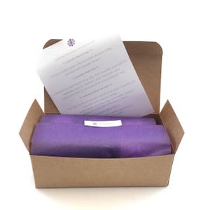 Inside of lavender bath and body gift set showing purple tissue and printed Lavessence insert