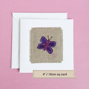 May include: A handmade card with a purple butterfly embroidered on a beige linen fabric. The card is 4 inches square.