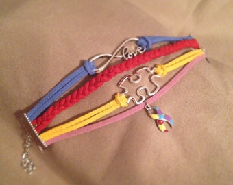 Multi-strand Blue, Red, Yellow & Purple Autism Awareness Suede Bracelet with Puzzle Piece, Love Infinity and Ribbon Charms