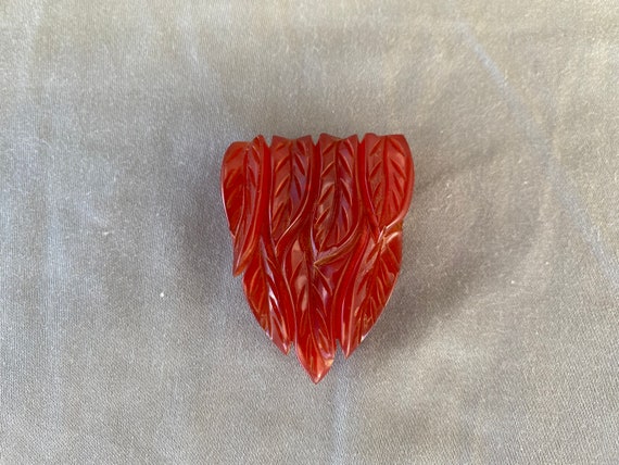 Vintage Red Bakelite Dress Clip With Art Deco Lea… - image 1