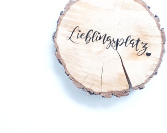 Tree slice with bark and individual lettering