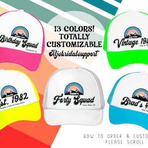 May include: Five different trucker hats with a mountain range and rainbow design. The hats are in various colors, including pink, green, yellow, white, and blue. The hats have text on them, including "Birthday Squad", "Vintage 1982", "Est. 1982", "Forty Squad", and "Brad's 40th".