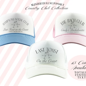 May include: Three white trucker hats with black text and a graphic of champagne glasses. The hats have different text on the front, including "Hamptons Social Club", "The Bach Club", and "Last Toast on the Coast". The hats are available in 13 colors.
