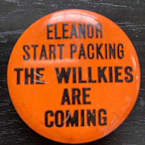 May include: Orange button with black text that reads "Eleanor Start Packing The Willkies Are Coming".