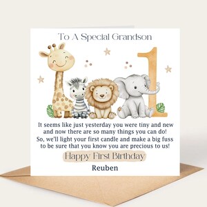 May include: A birthday card with a watercolor illustration of a giraffe, zebra, lion, and elephant. The card reads "To A Special Grandson" and "Happy First Birthday Reuben". The number "1" is also featured.