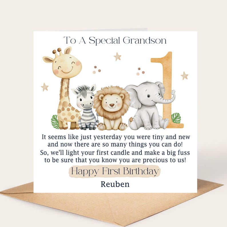 May include: A birthday card with a watercolor illustration of a giraffe, zebra, lion, and elephant. The card reads "To A Special Grandson" and "Happy First Birthday Reuben". The number "1" is also featured.