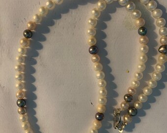 Beautiful white, pink and black cultured pearl single strand necklace 17" necklace with sterling silver clasp.