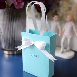 Breakfast at Tiffany favor bags. Elegant Bags for guests with satin ribbon handles and custom name