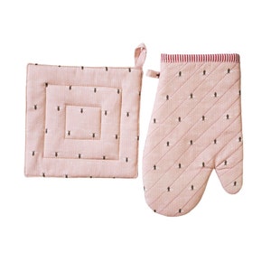 May include: A pink quilted oven mitt and matching square pot holder set. The set features a small black bee pattern on a dotted background. The top of the oven mitt has a red and white striped trim, and both pieces have a loop for hanging.