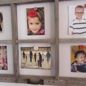 May include: A rustic wooden frame displaying six photographs, each held in place by decorative buttons. The photos feature portraits of people and family scenes, creating a personalized and charming display.