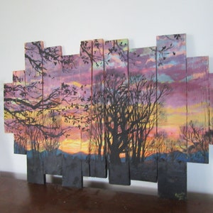 May include: A sunset scene painted on wooden planks. The painting features a silhouette of trees against a colorful sky with shades of pink, purple, orange, and yellow. The planks are arranged in a staggered pattern to create a unique and rustic look.